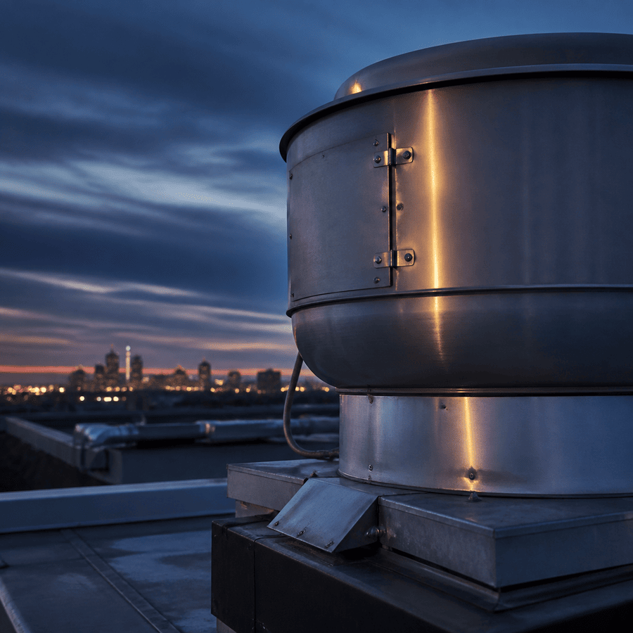 Commercial rooftop exhaust fan above Indianapolis at blue hour